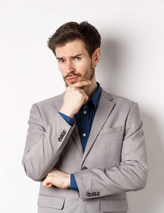 stock-photo-hesitant-young-businessman-in-suit-looking-skeptical-at-camera-thinking-and-making-decision-2495901163-(1)